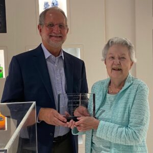 Dennis Birke awards Metta Lou Henderson the AIHP Fischelis Award in 2021